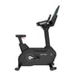 Black upright exercise bike with padded seat, fixed handlebars, and digital display on white background