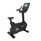 Black upright exercise bike with digital touchscreen display, handlebars, and seat on white background