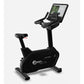 Black upright exercise bike with digital touchscreen display showing workout metrics, padded seat, handlebars, and foot pedal