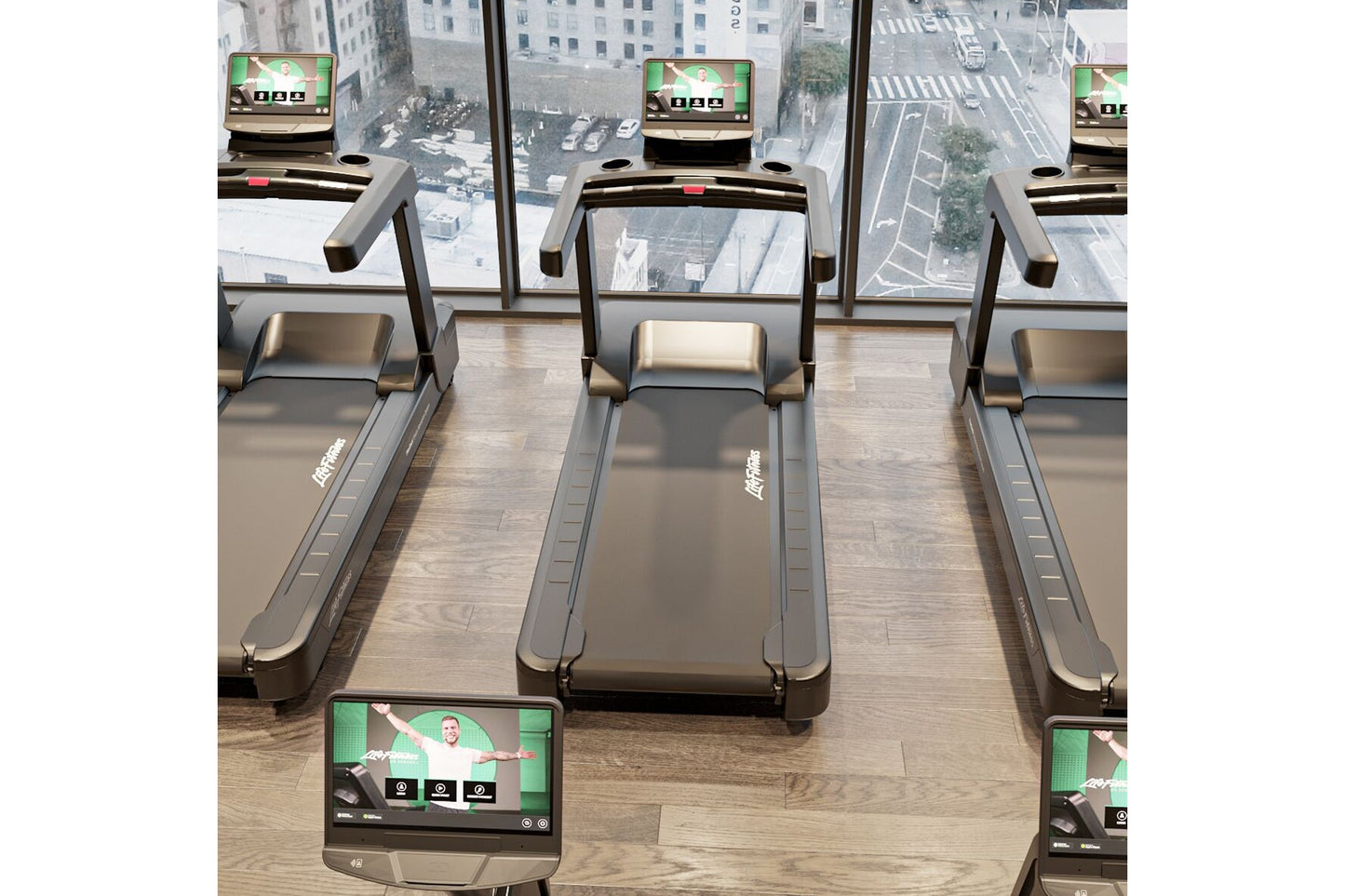 Row of Life Fitness Integrity+ treadmills with gray frames and touchscreen displays in high-rise gym with city views