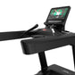 Black Life Fitness treadmill with digital touchscreen display showing workout content, handrails, and microphone on white bac
