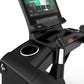 Black stationary exercise bike with integrated tablet holder displaying Life Fitness app interface, featuring console control