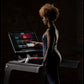 Woman wearing dark blue athletic tank top using Life Fitness Integrity+ treadmill with digital touchscreen display against bl