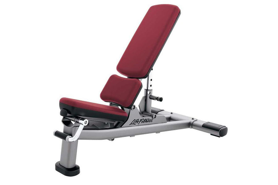 Life Fitness adjustable weight bench with burgundy padded seat and back, gray metal frame, and leg extension attachment on wh
