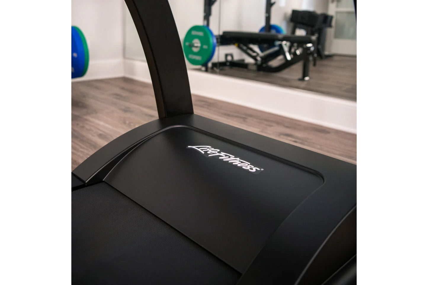 Black Life Fitness Run CX treadmill with branded display panel in gym setting with weights and equipment visible in backgroun