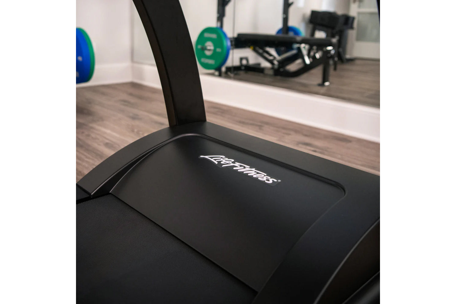 Black Life Fitness Run CX treadmill with branded display panel in gym setting with weights and equipment visible in backgroun
