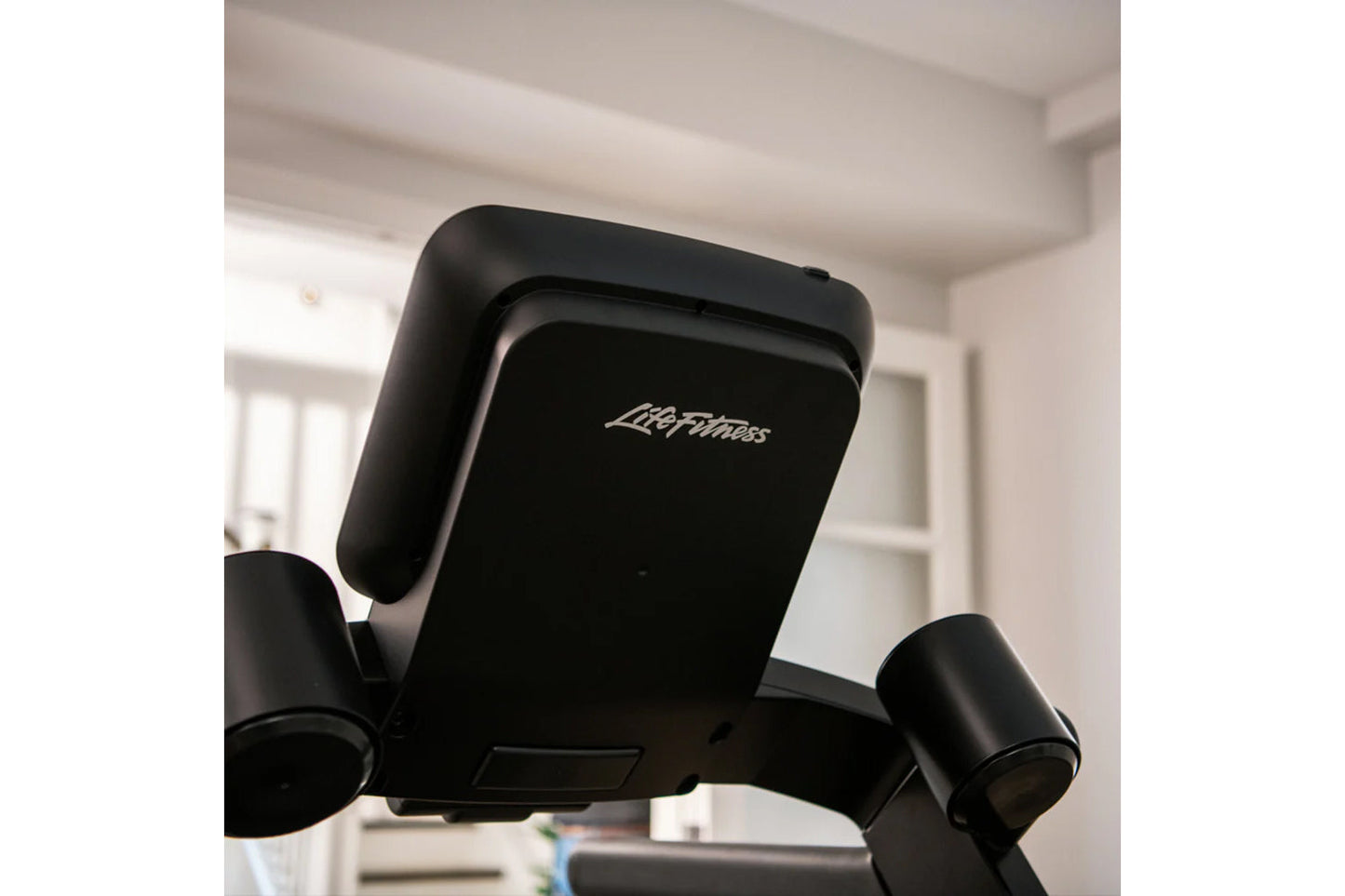 Black Life Fitness Run CX treadmill console with branded display and side handles, shown indoors