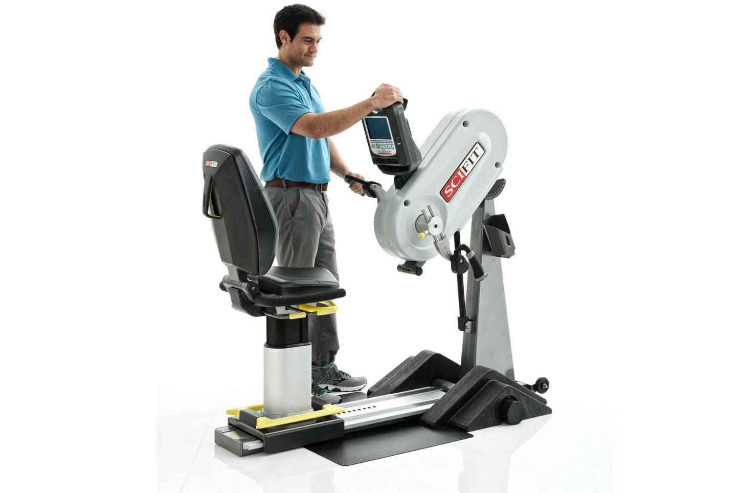 Man in blue polo shirt using white and black upper body exercise machine with digital console display on white background