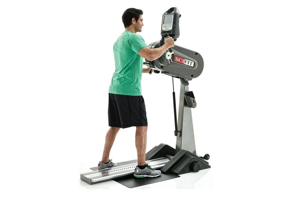 Male model in green t-shirt using gray and black SCIFIT PRO1 upper body exerciser with digital display, shown in side profile
