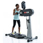 Woman in light blue tank top using black and gray SCIFIT PRO1 standing upper body ergometer with smartphone holder, on white 