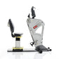 Scifit Pro2 Total Body Exercise Trainer with gray frame, black padded seat and backrest, dual handles, and foot pedals on whi