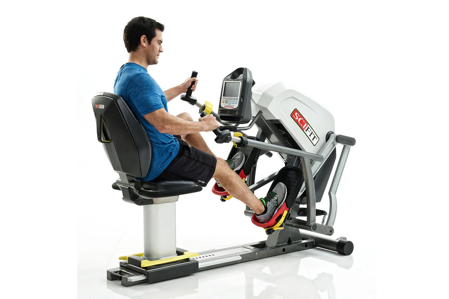 Man in blue shirt using white and black recumbent stepper machine with digital display, on white background