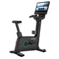 Black upright exercise bike with cyan accents, digital touchscreen display, adjustable seat and handlebars, on white backgrou