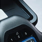 Gray textured exercise bike handlebar with numbered button controls and blue accent trim, close-up detail view