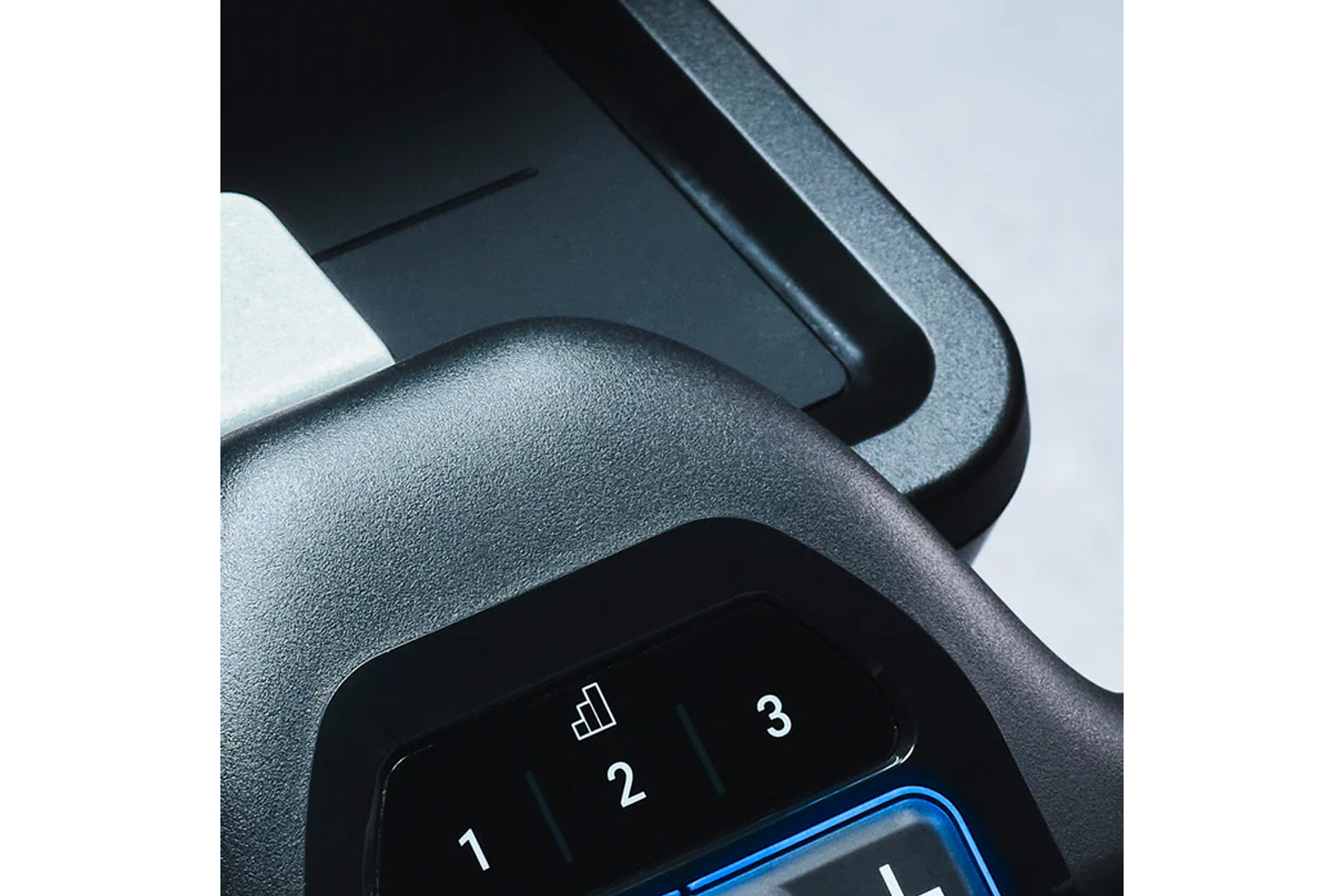 Gray textured exercise bike handlebar with numbered button controls and blue accent trim, close-up detail view