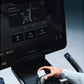 Life Fitness Symbio stationary exercise bike with tablet display showing SwitchCycle workout app, held by person in white sle