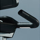 Black and silver exercise bike handlebar with ergonomic grip on blue background