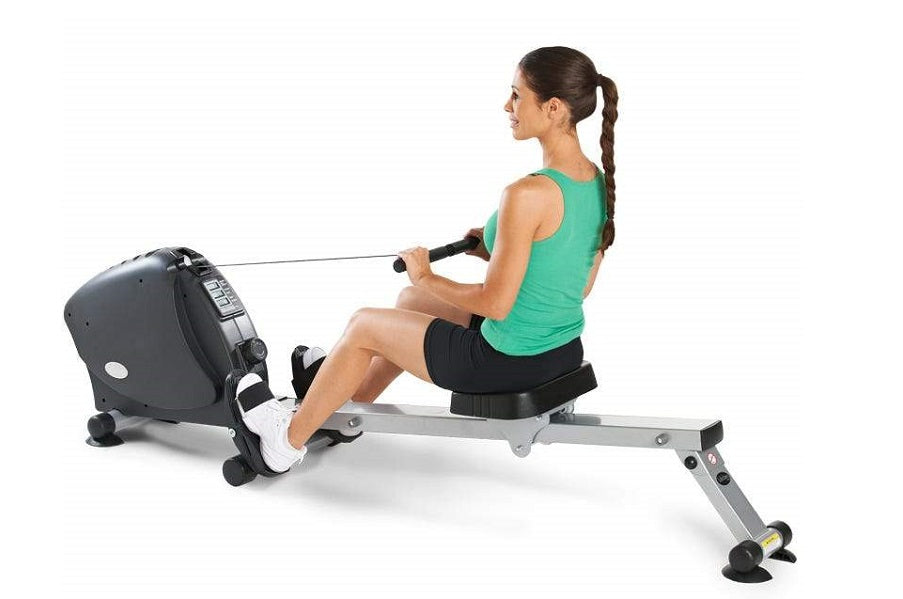 Woman using black and gray LifeSpan RW1000 indoor rowing machine, wearing green tank top and black shorts