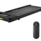 Black under-desk treadmill with textured running surface and control panel, shown with black remote control featuring start a