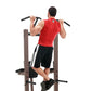 Warrior VKR/Dip Power Tower with man performing dip exercise in red sleeveless shirt, viewed from behind