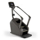 Matrix C50 black stair-climbing machine with digital touchscreen display and gold accents, on white background