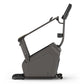 Black Matrix upright exercise bike with curved frame, handlebar with digital display, and foot pedals on white background