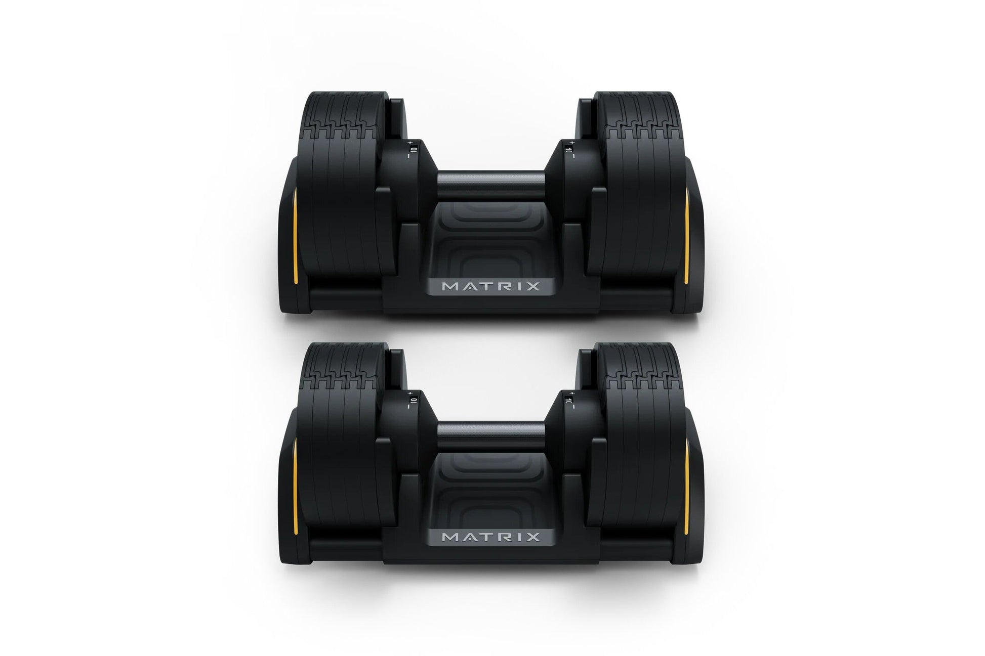 Pair of black Matrix adjustable dumbbells with yellow accents and textured grip handles, displayed on white background