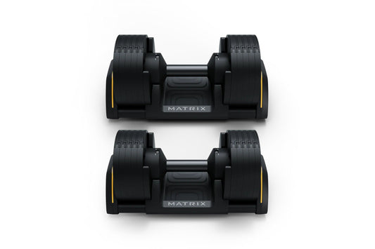 Pair of black Matrix adjustable dumbbells with yellow accents and textured grip handles, displayed on white background