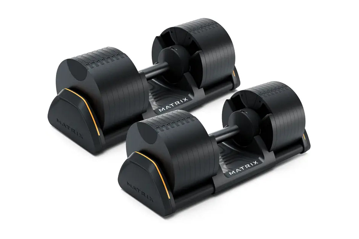 Pair of black Matrix adjustable dumbbells with gold accents on bases, shown on white background