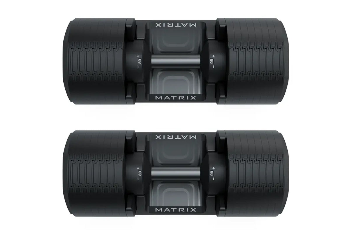 Pair of Matrix black adjustable dumbbells with textured rubber handles, weight adjustment knobs, and Matrix branding on cente