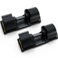 Pair of Matrix adjustable dumbbells with black rubber grip plates, steel handles, and yellow accents on base, shown on white 