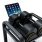 Matrix DBSR black adjustable dumbbell storage rack with tablet holder and yellow accent trim, holding multiple dumbbells with