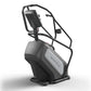 Matrix Endurance ClimbMill with black and gray frame, digital display console, and dual handlebar grips on white background
