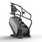 Matrix Endurance ClimbMill stair climber with black frame, gray accent panel, digital display console, and handlebar grips on