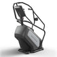 Matrix Endurance ClimbMill stair climbing machine with black frame, gray seat panel, and digital console on white background