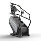 Matrix Endurance ClimbMill with black frame, gray step platform, digital console, and handlebar grips on white background