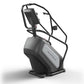 Matrix Endurance ClimbMill with black frame, gray accent panel, and overhead handlebar display on white background