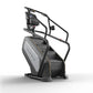 Matrix Endurance ClimbMill with black frame, gray and black seat, digital display console, and sturdy handrails on white back