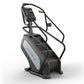 Matrix Endurance ClimbMill with digital display console, black frame, white panel, and dual handrails on white background