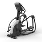 Matrix Endurance elliptical machine with black frame, white accent panels, digital display console, and dual foot pedals on w