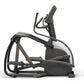 Matrix Endurance elliptical trainer with black and gray frame, dual handles, and white seat pad on white background