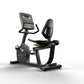 Matrix Endurance recumbent exercise bike with digital display console, black frame, and padded seat on white background