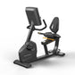 Matrix Endurance recumbent exercise bike with black frame, digital display monitor, padded seat and backrest, on white backgr