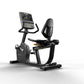 Matrix Endurance black recumbent exercise bike with digital display console and padded seat, on white background