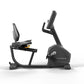 Matrix Endurance black recumbent exercise bike with upright console and padded seat, shown on white background