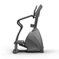Matrix Endurance Stepper with gray and black frame, curved handlebar, digital display, and foot pedals on white background