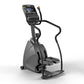 Black and gray commercial stepper machine with digital touchscreen display and dual handles, on white background