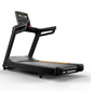 Black motorized treadmill with digital display console, handrails, and orange accent stripe on running belt, on white backgro