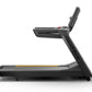 Matrix Endurance treadmill with black frame, digital console, and yellow accent stripe on running belt, side view