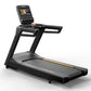 Matrix Endurance black treadmill with digital touchscreen display and yellow accent stripe on running deck, on white backgrou
